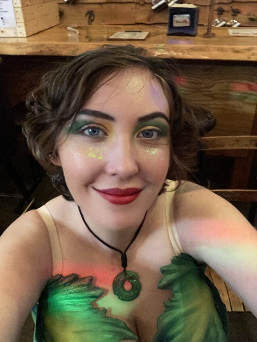 Mermaid with shimmering green and gold face paint